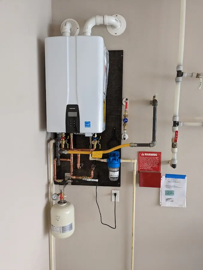 Professional plumber installing copper piping in a Fairbanks home